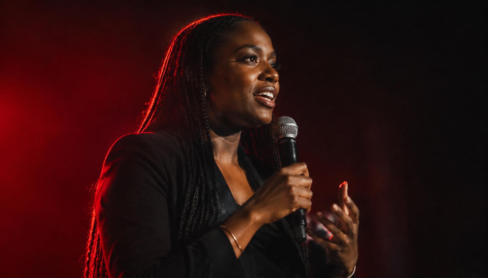 A speaker on stage in red light